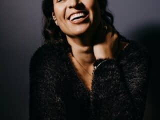 smiling woman in black fur coat