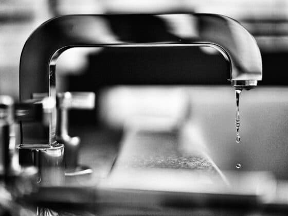 grayscale photography of faucet