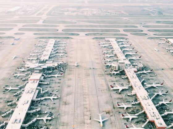 aerial view of airport with lots of airplanes during daytime