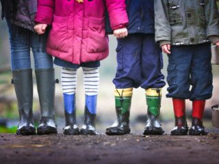 Keeping Children Active Can Help Them Reach Their Full Potential four children standing on dirt during daytime
