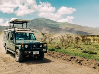 Discovering Rwanda's Secret Big Five Safari in Akagera black jeep wrangler on dirt road during daytime