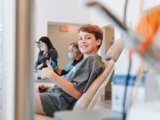 How to Prevent Cavities in Children: Tips Every Parent Should Know man in blue denim jacket sitting on chair